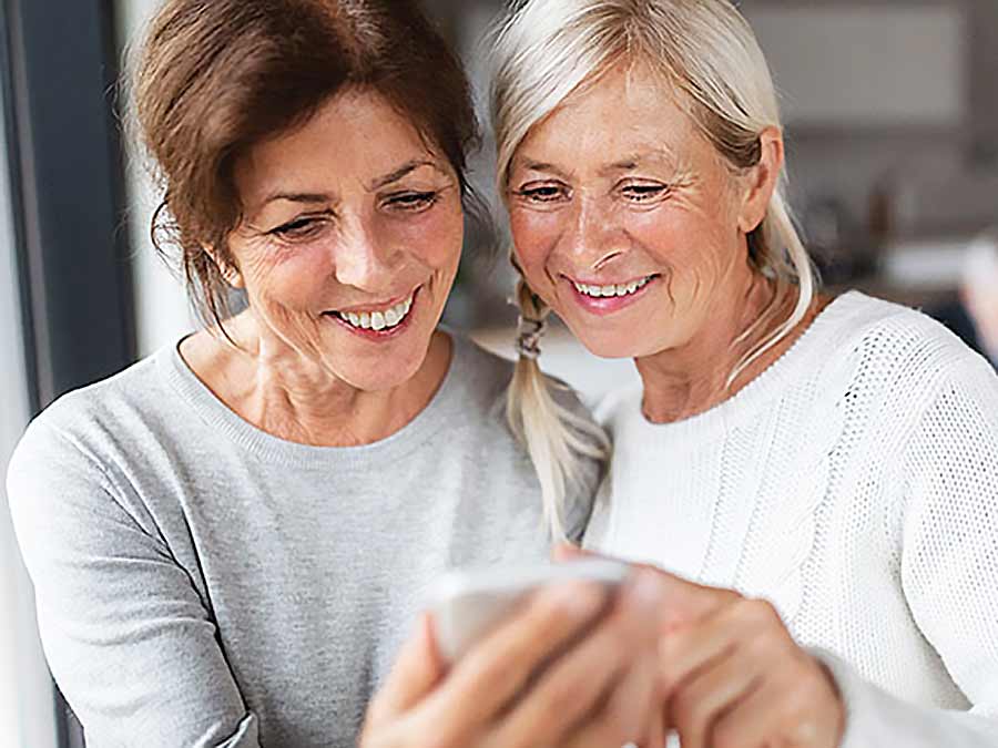 Friends read about hearing care advice on online from Amplify Hearing